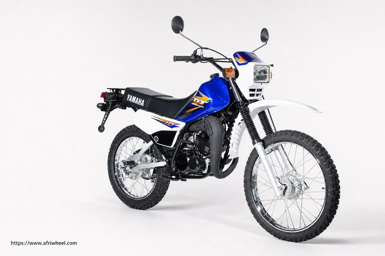 Yamaha DT175 in Cyan Metallic 3, right front three-quarter studio view with wire-spoke wheels