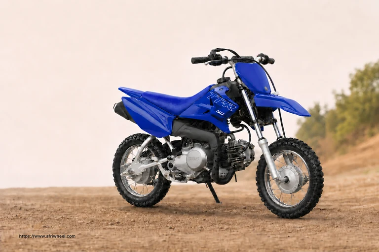 Yamaha TT-R50E in Team Yamaha Blue, front three-quarter hero view on an off-road surface
